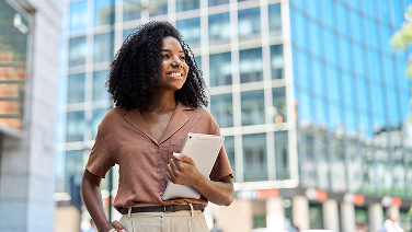 happy-young-african-american-professional-woman-looking-away-standing-city 1