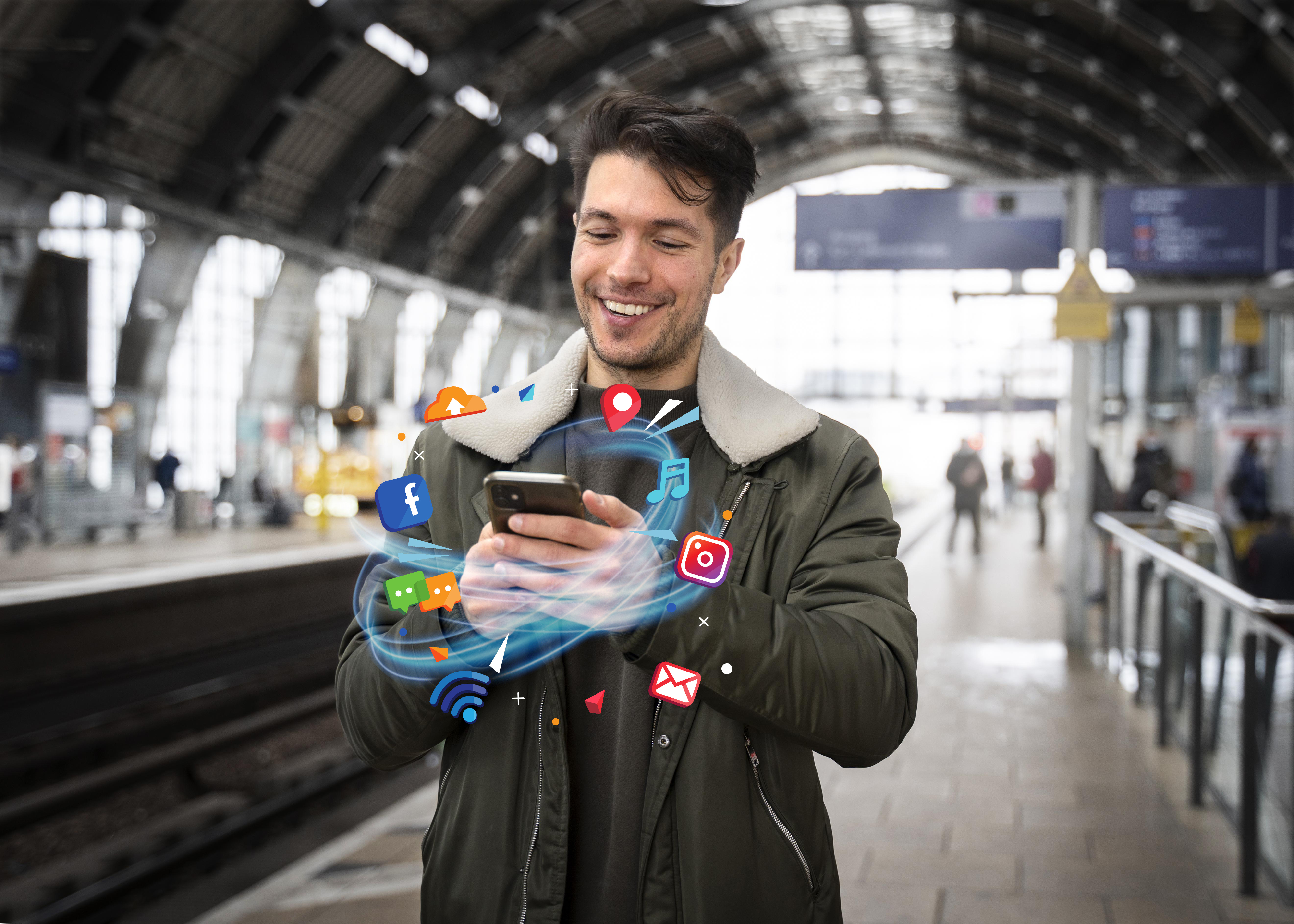 Person using phone in German train station